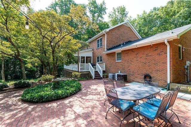 view of patio featuring central AC unit and a deck