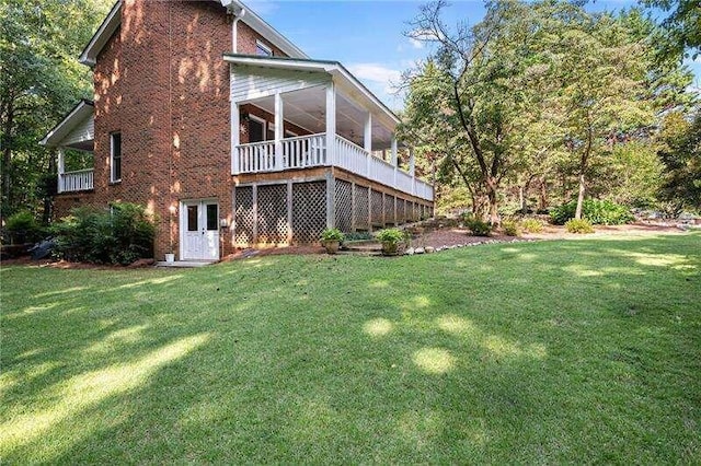 rear view of property with a lawn