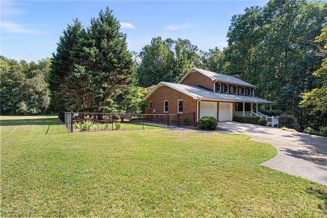 view of front facade with a garage and a front lawn