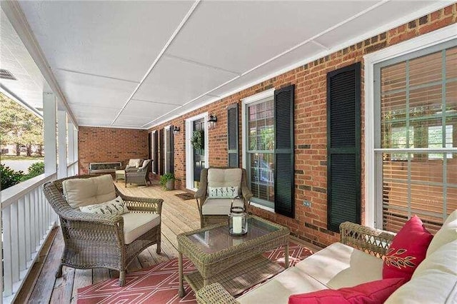 exterior space featuring covered porch and an outdoor hangout area