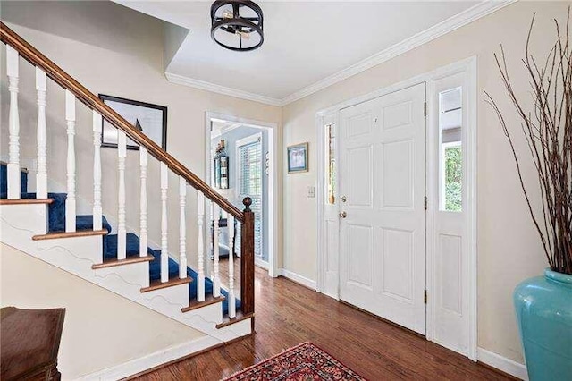 foyer entrance featuring dark hardwood / wood-style flooring and ornamental molding