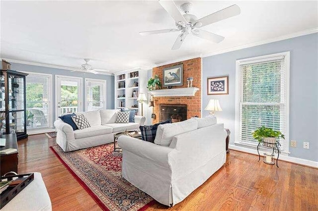 living room featuring a fireplace, plenty of natural light, and crown molding