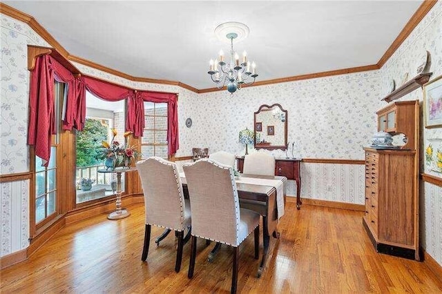 dining space with a notable chandelier, a wealth of natural light, and wood-type flooring