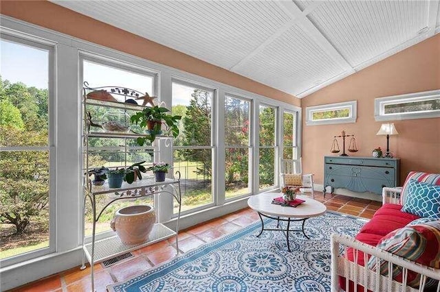 sunroom featuring lofted ceiling and plenty of natural light