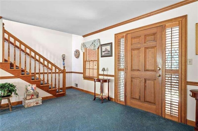 entryway featuring a healthy amount of sunlight, ornamental molding, and dark carpet