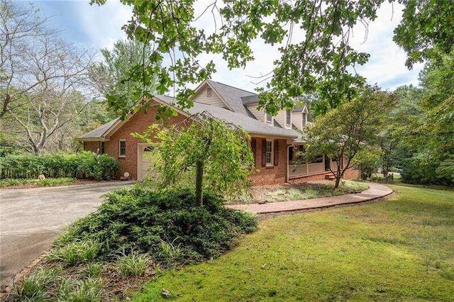 exterior space featuring a garage and a lawn