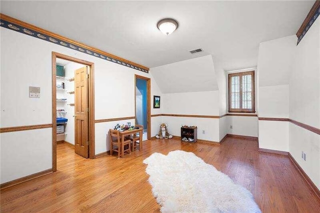 interior space with vaulted ceiling and light wood-type flooring