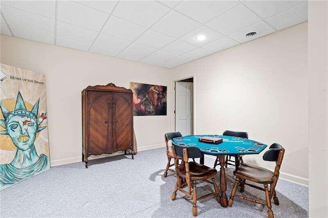 dining space featuring a paneled ceiling and carpet