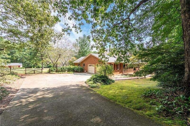 view of front of house featuring a garage and a front lawn