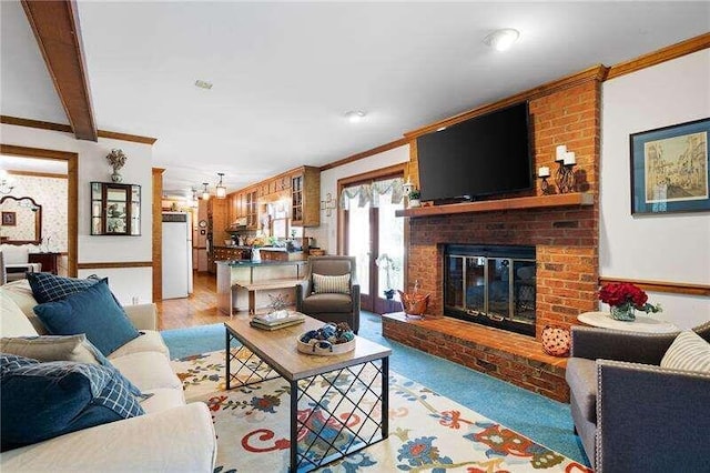 living room featuring a fireplace, brick wall, and light hardwood / wood-style flooring