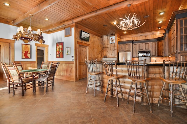 686 Lake Dr, Morganton, GA 30560 - interior space with hanging light fixtures, stainless steel fridge, a notable chandelier, a kitchen bar, and wood ceiling