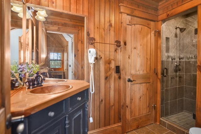 686 Lake Dr, Morganton, GA 30560 - bathroom featuring a shower with shower door, tile floors, wooden walls, and vanity with extensive cabinet space
