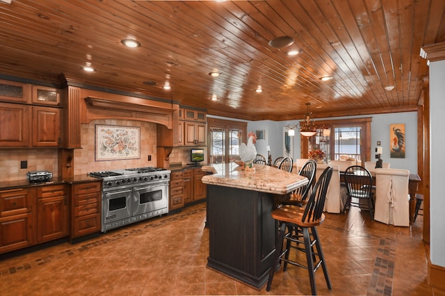 686 Lake Dr, Morganton, GA 30560 - kitchen with dark tile flooring, double oven range, tasteful backsplash, and a breakfast bar