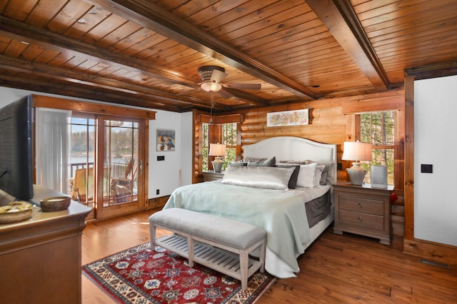 686 Lake Dr, Morganton, GA 30560 - bedroom with beamed ceiling, ceiling fan, log walls, dark hardwood / wood-style flooring, and access to outside