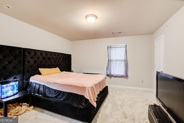 bedroom featuring light carpet