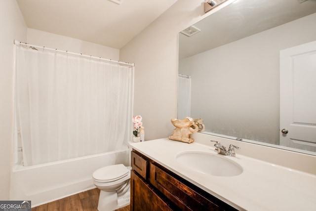 full bathroom featuring vanity, wood-type flooring, shower / bath combo, and toilet