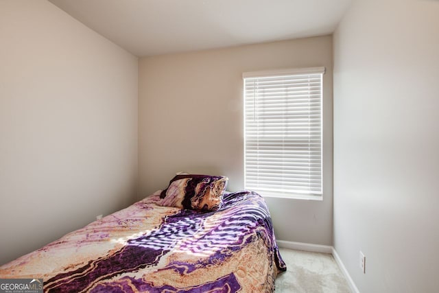 carpeted bedroom featuring multiple windows