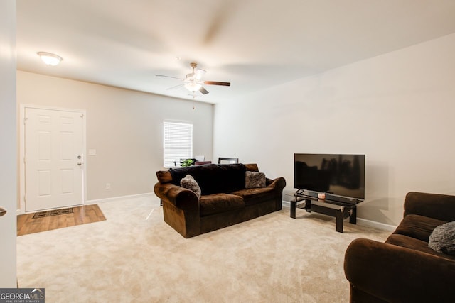 carpeted living room featuring ceiling fan