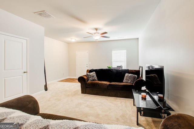 living room with light colored carpet and ceiling fan