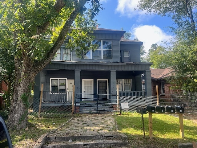 view of front of property featuring covered porch and a front yard