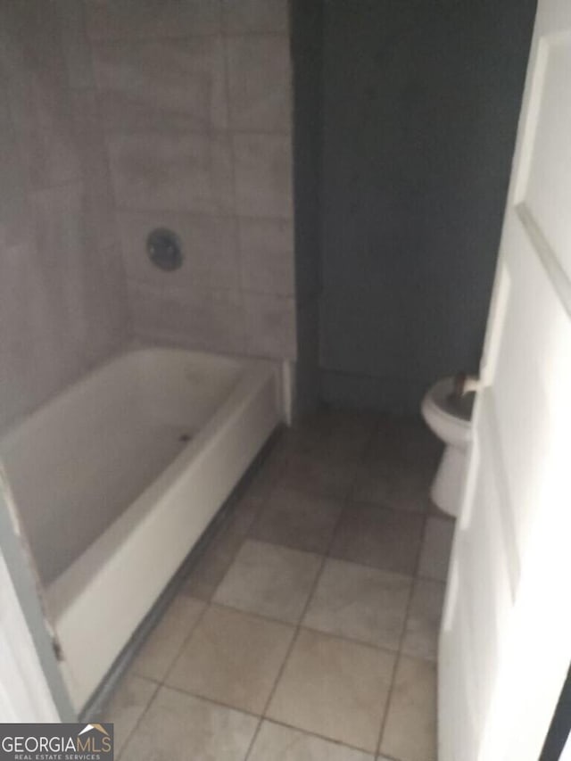 bathroom with toilet and tile patterned floors