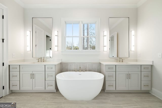 bathroom featuring tile patterned flooring, vanity, and a washtub