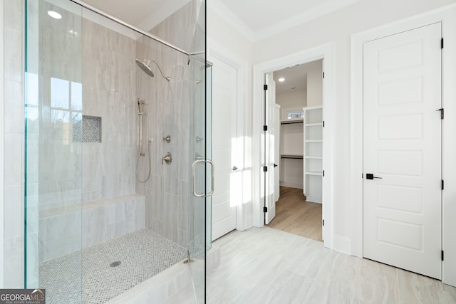 bathroom featuring a shower with shower door