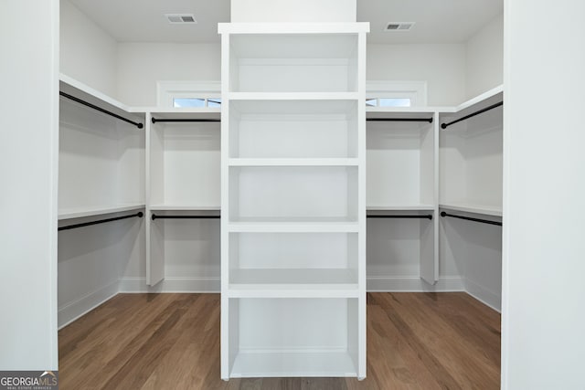 walk in closet with hardwood / wood-style flooring