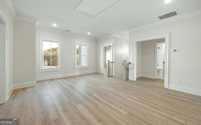 unfurnished room with crown molding and light hardwood / wood-style floors