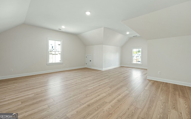 bonus room featuring vaulted ceiling and light wood-type flooring