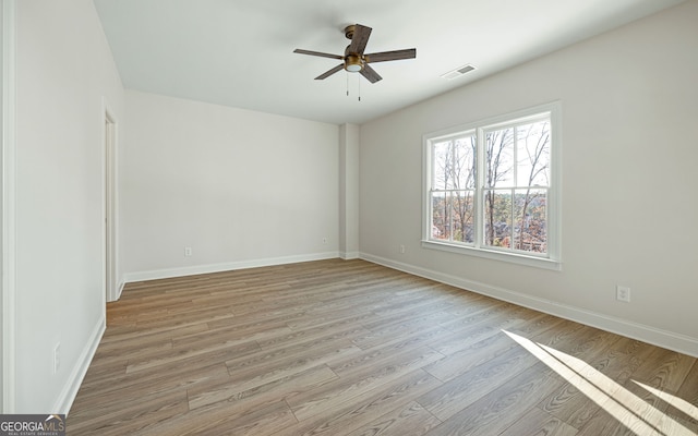 empty room featuring light hardwood / wood-style flooring and ceiling fan