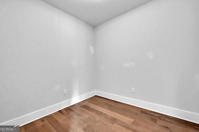 spare room with hardwood / wood-style floors