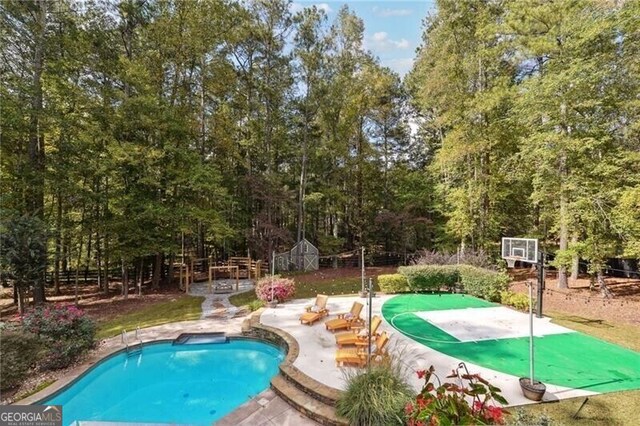 view of swimming pool with a patio area