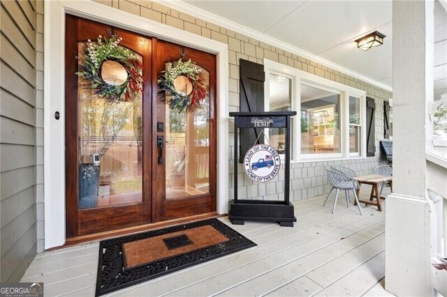 doorway to property featuring a porch