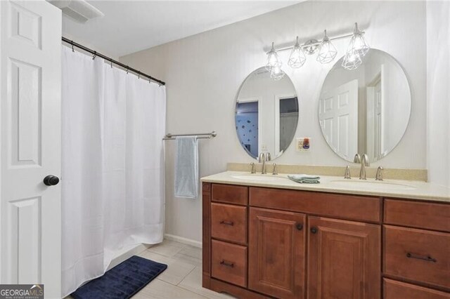 bathroom with tile patterned flooring and double sink vanity