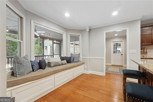 interior space with light hardwood / wood-style floors and crown molding