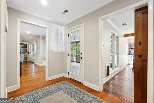 entryway featuring crown molding and hardwood / wood-style floors