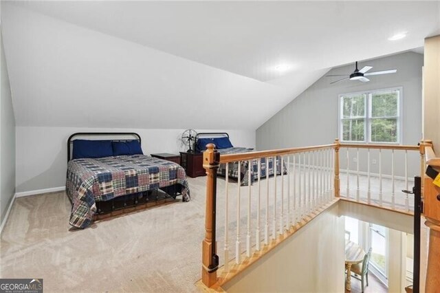 bedroom featuring lofted ceiling, carpet floors, and ceiling fan