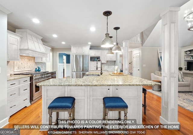 kitchen with light hardwood / wood-style flooring, white cabinets, stainless steel appliances, custom exhaust hood, and decorative backsplash