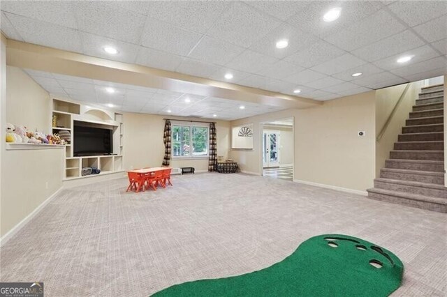 game room with built in shelves, a drop ceiling, and carpet