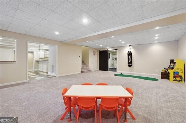 playroom with a drop ceiling and carpet floors