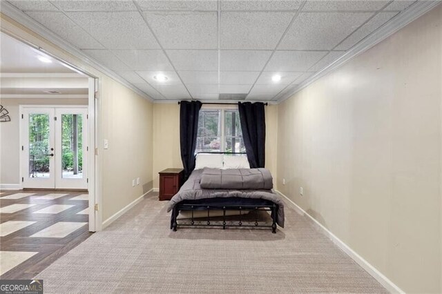 carpeted bedroom featuring french doors and a paneled ceiling