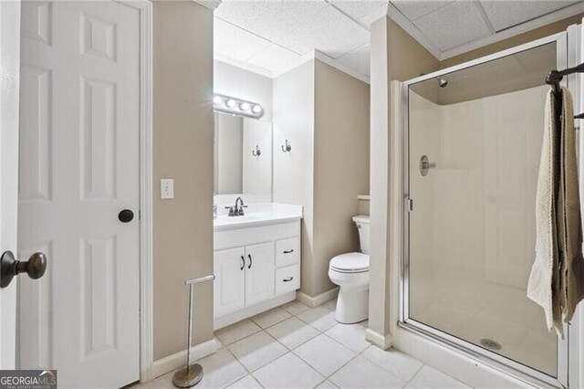 bathroom featuring walk in shower, vanity, a paneled ceiling, and tile patterned flooring