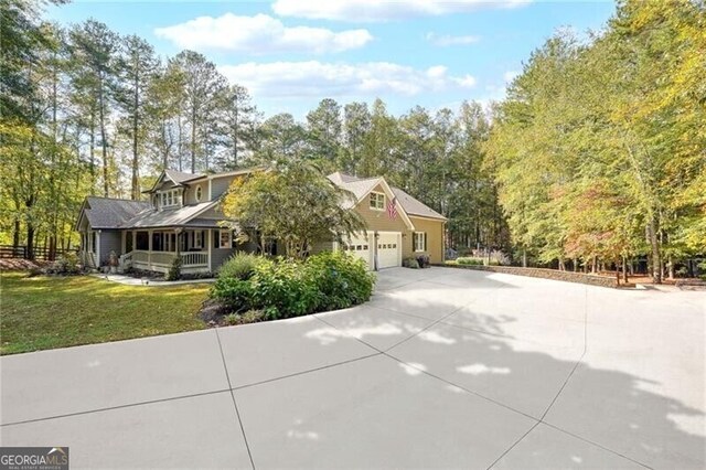 view of side of home with a garage and a lawn