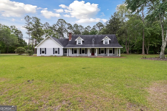 cape cod home featuring a front lawn