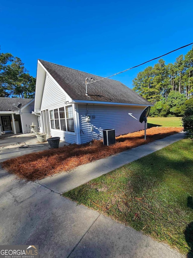 view of property exterior with a yard