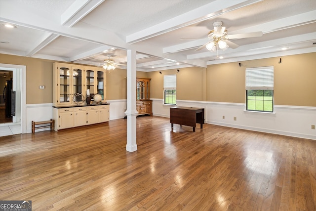 interior space with light hardwood / wood-style floors, beam ceiling, and ceiling fan