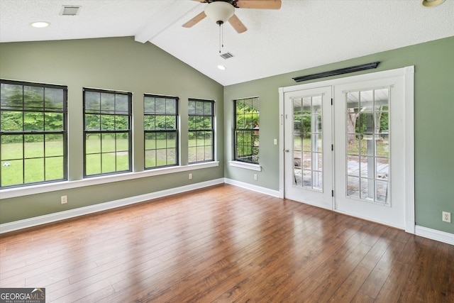 unfurnished room with ceiling fan, dark hardwood / wood-style floors, and vaulted ceiling with beams