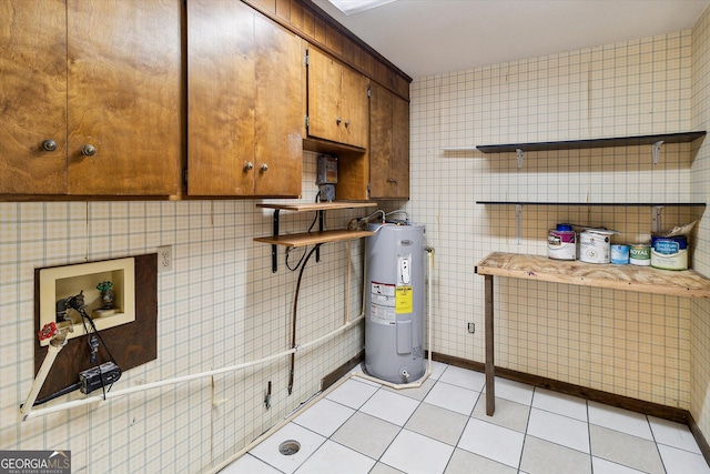 interior space featuring light tile flooring, tile walls, and electric water heater