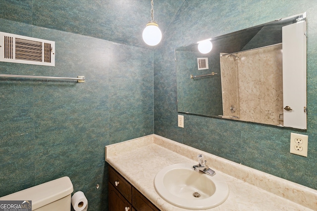 bathroom featuring toilet and vanity